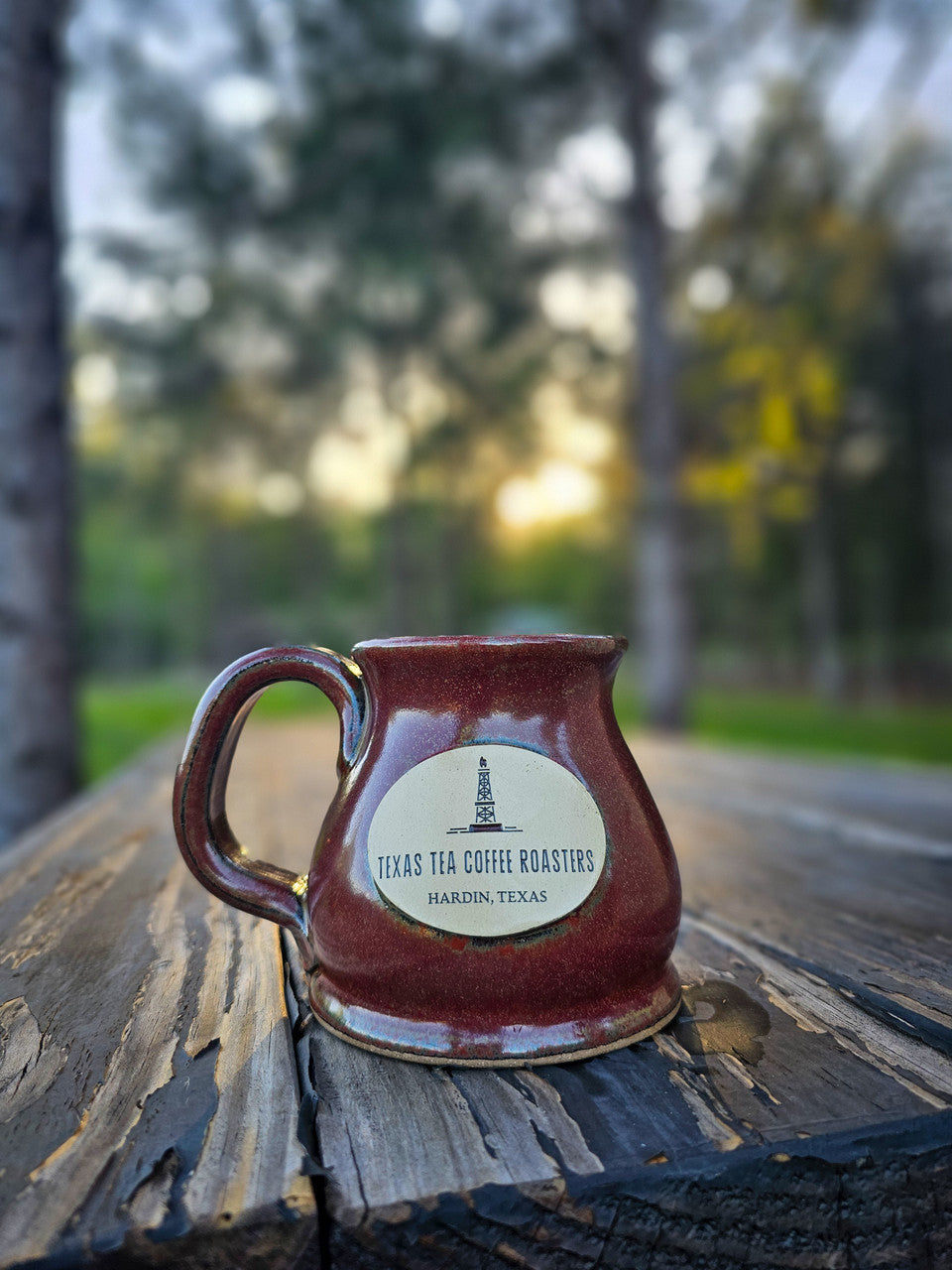 stoneware mug on table and sunset in background