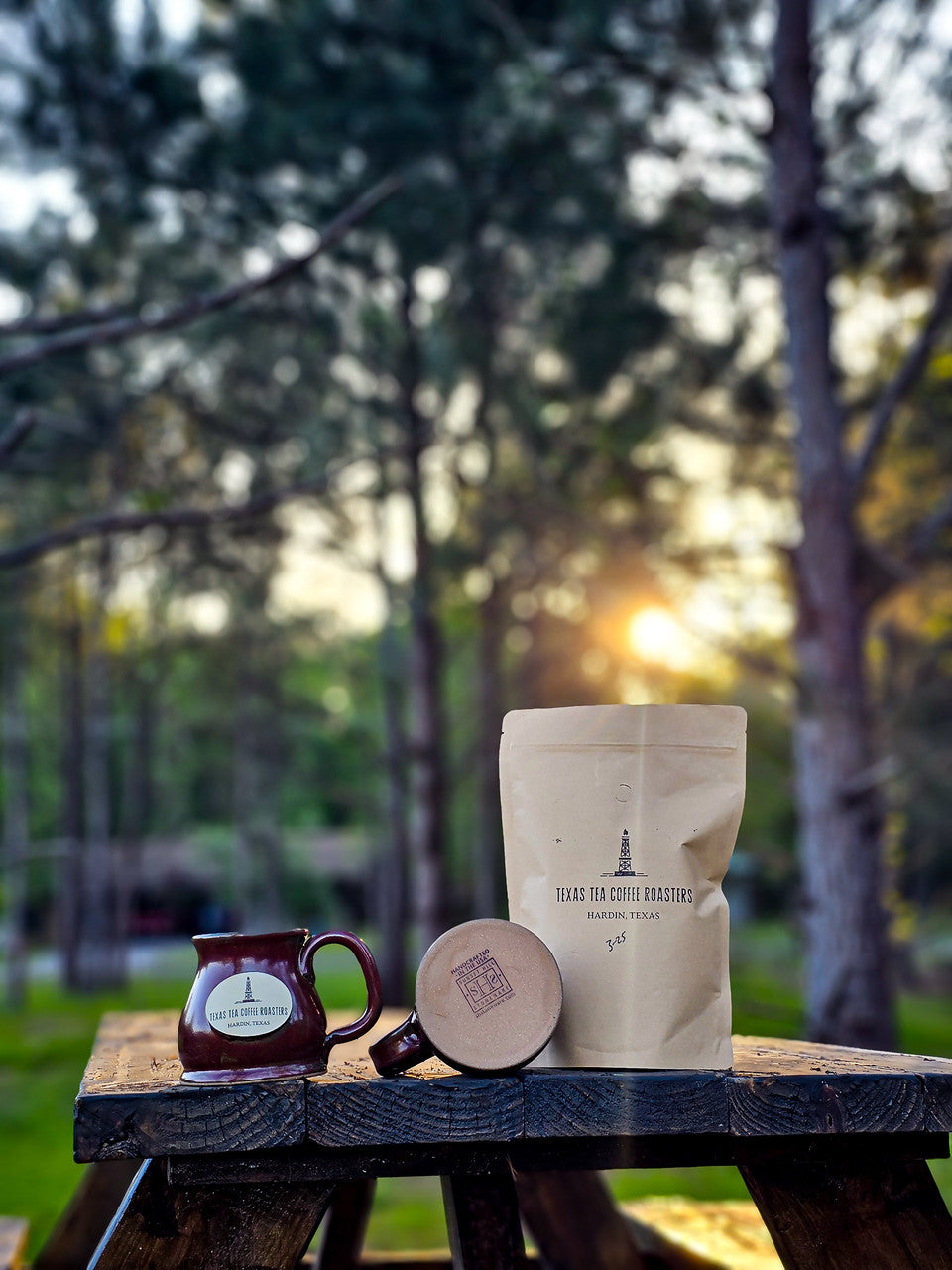 stoneware mugs and coffee bag, sunset in background