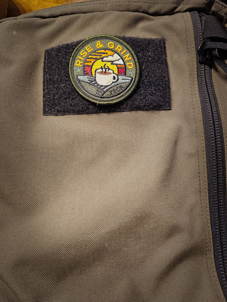 rise and grind patch on backpack